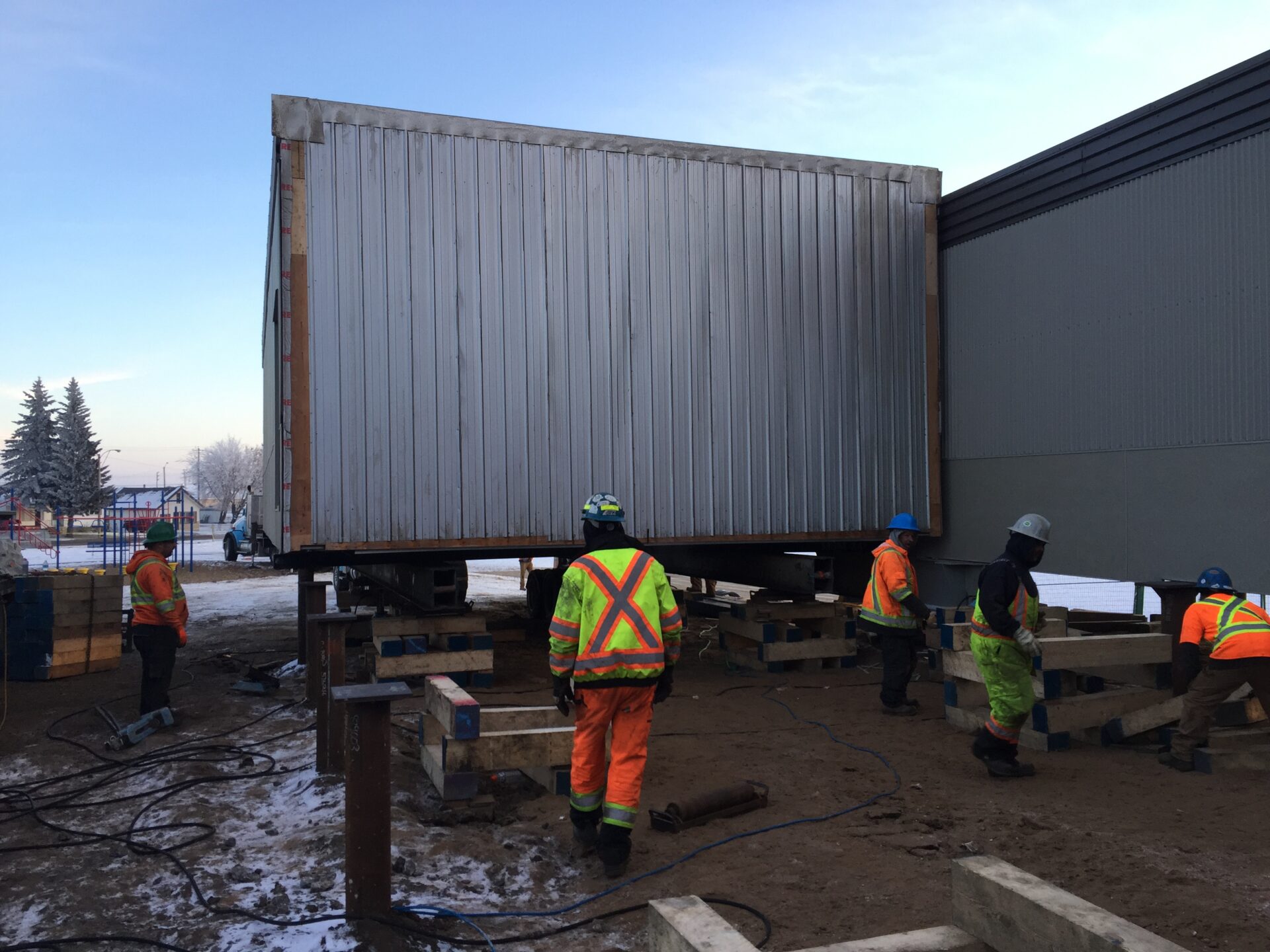 Construction workers on lift wearing safety equipment